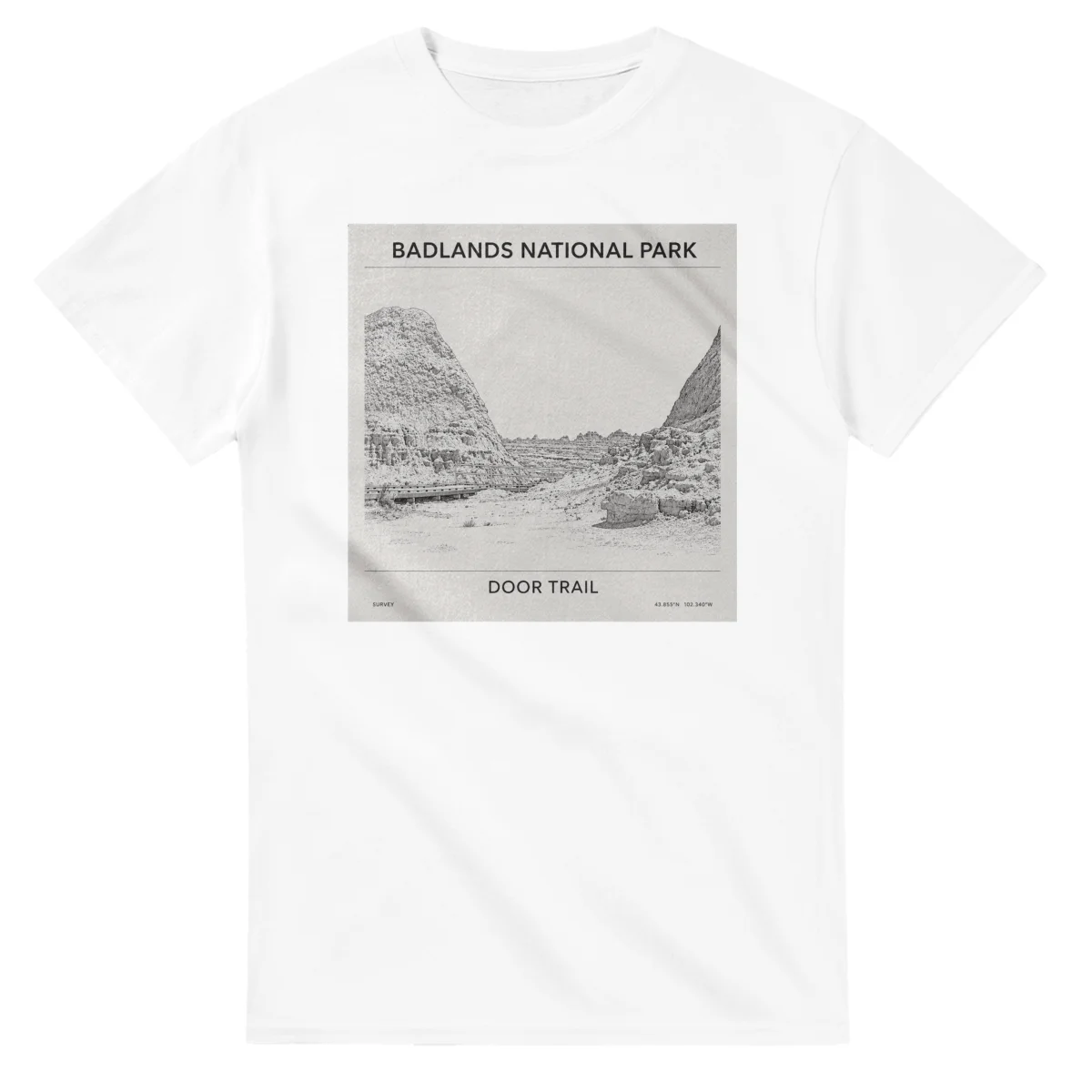 Fine-line engraving-style drawing for Badlands National Park, with a landmark caption and small coordinate text.