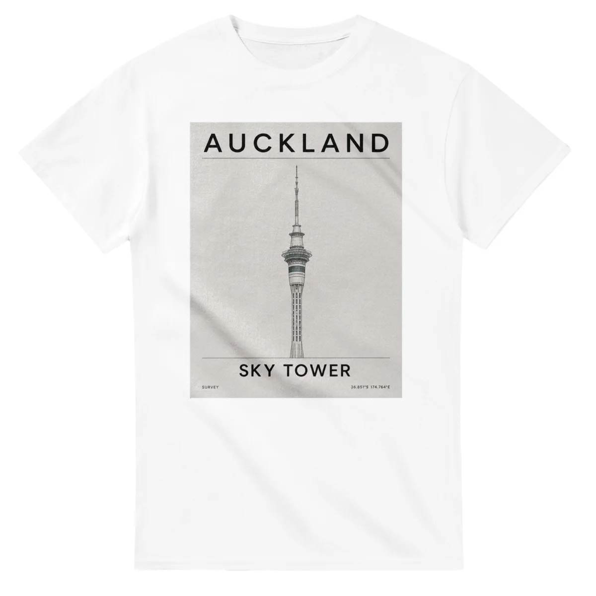 Fine-line engraving-style drawing for Auckland, with a landmark caption and small coordinate text.